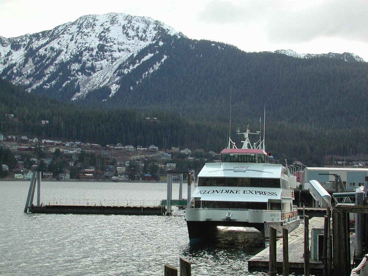 Klondike Express at Juneau wharf, Douglas Island in the background