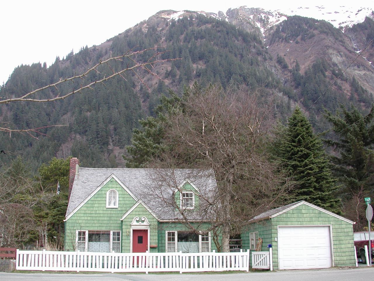 Old style Juneau beneath towering mountains