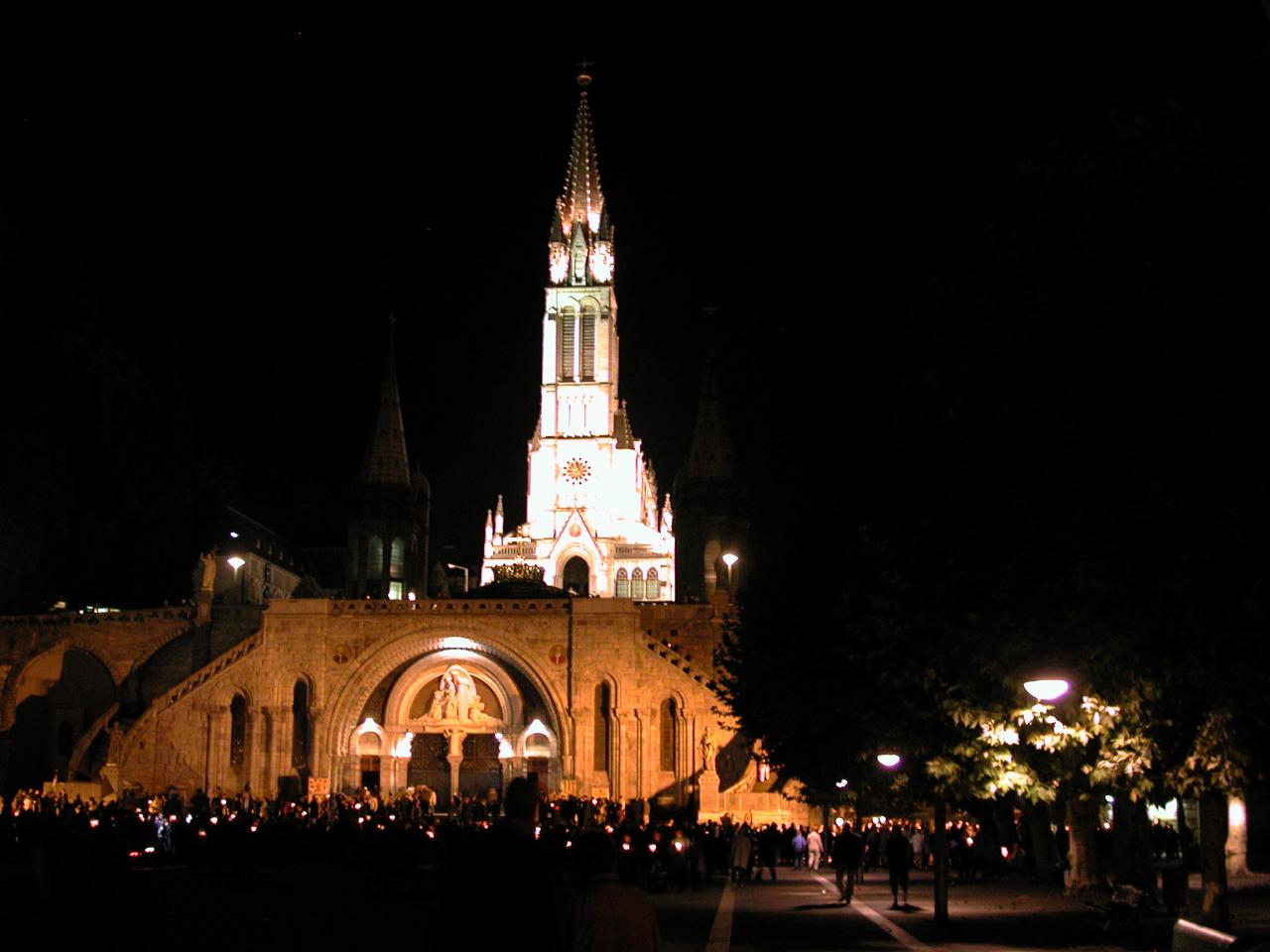 Gathering around the cathedral at end of procession and cathedral spire now illuminated
