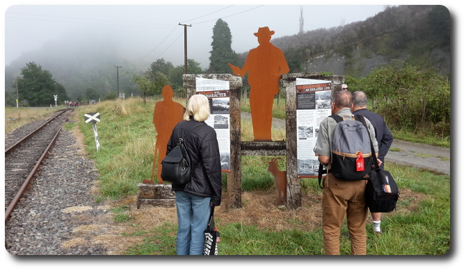 Two signs, siloette and onlookers