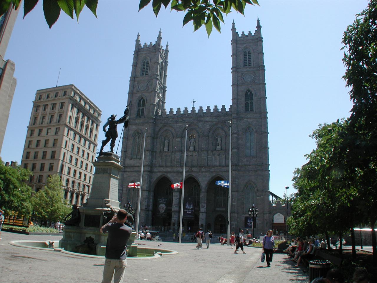 Basilica of Notre Dame, Motnreal, from Place d'Armes, statue of city founder Maisonneuve