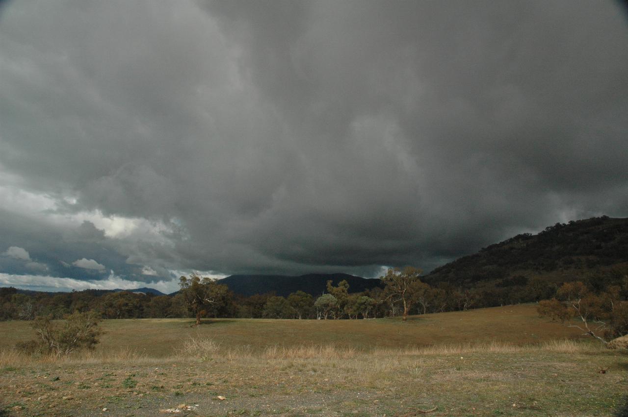 Dark clouds over brown pastures