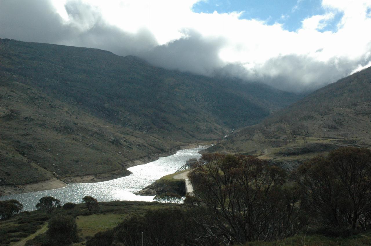 Dam, wall barely visible, sunlight reflecting off water