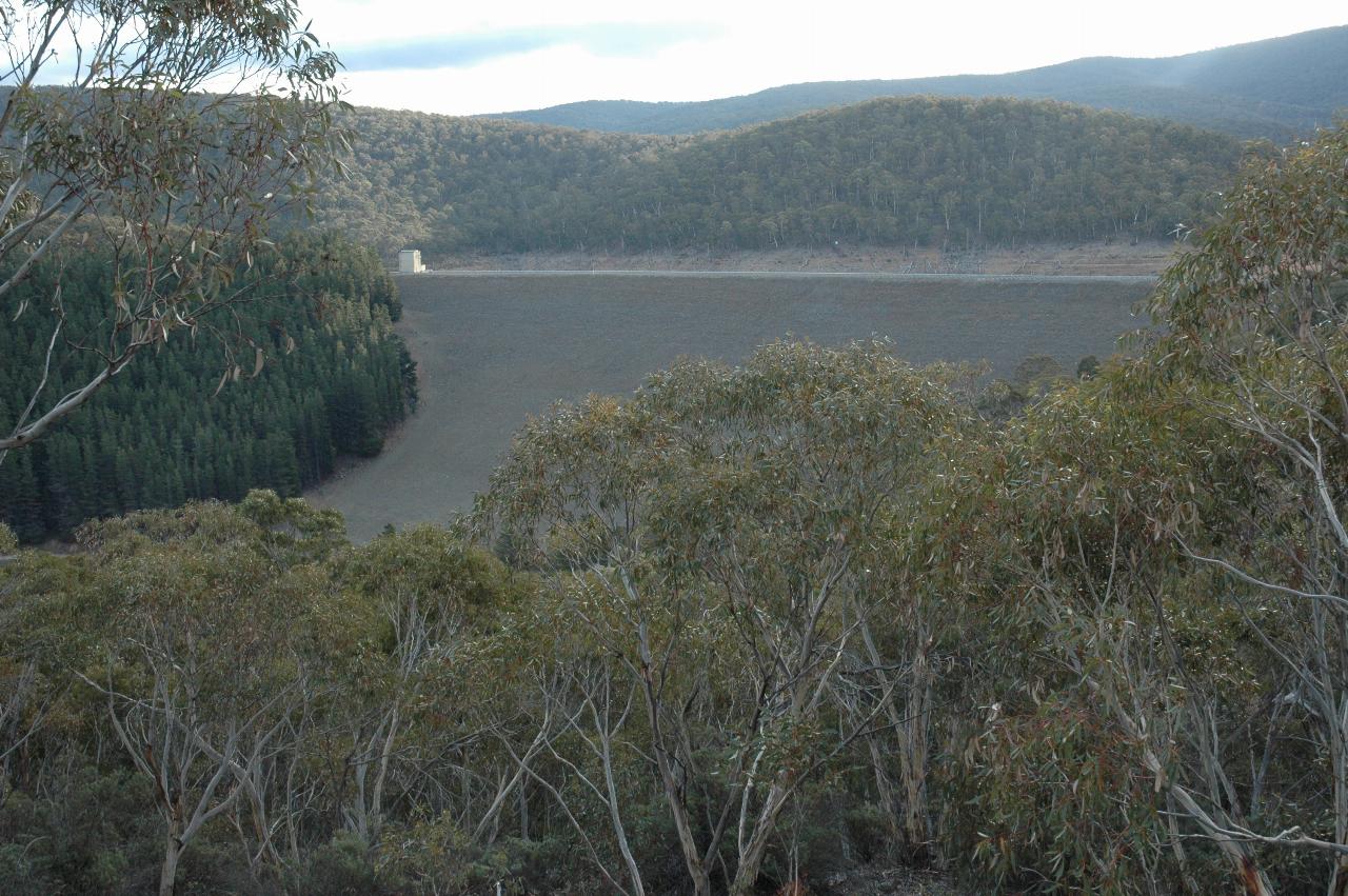 Ground level view of front of earthen dam wall