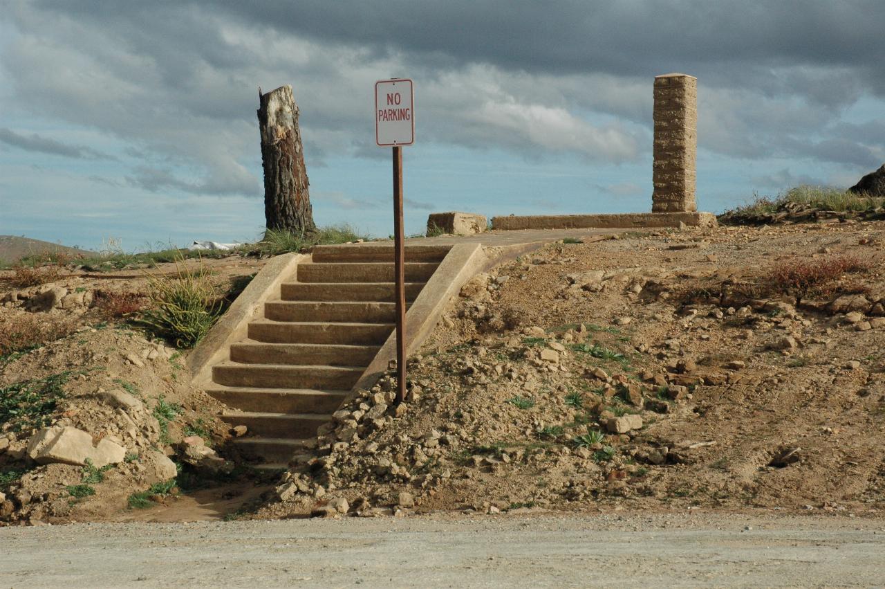 Steps and No Parking sign of flooded town
