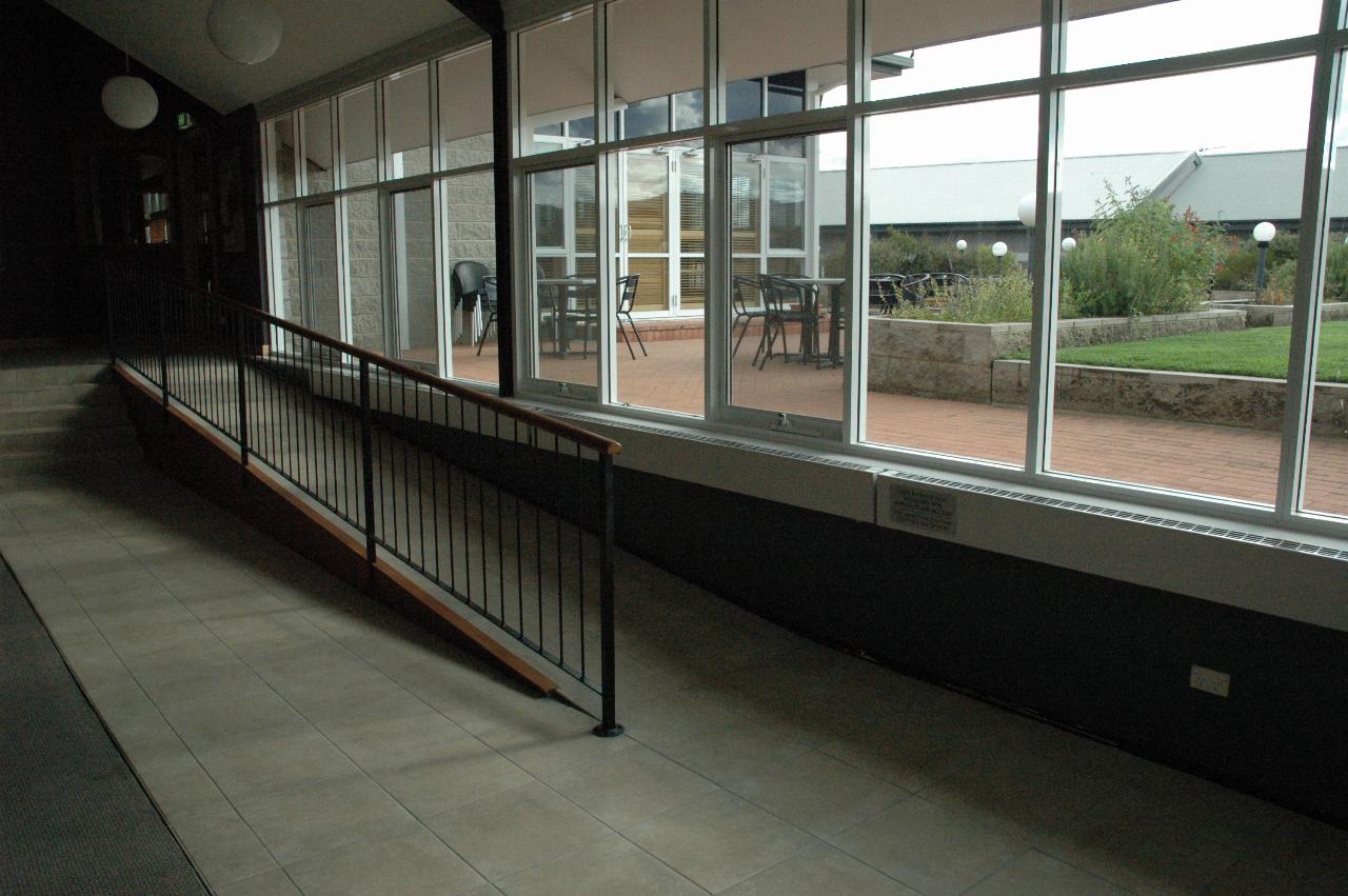 Room with a ramp beside stairs